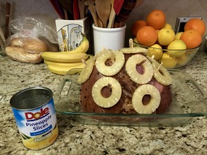 Adding pineapple rings to the ham