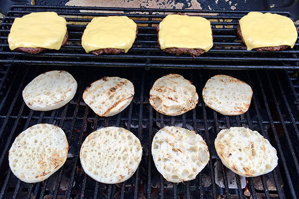 Grilling the burgers with toasted English muffins and sharp cheddar slices!